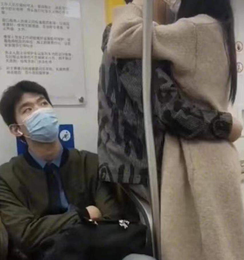 情侣在地铁上深情相拥,旁边小哥表情亮了